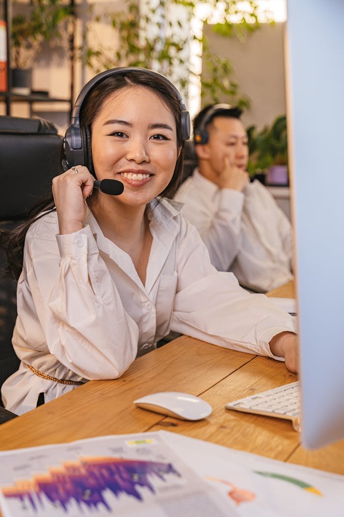 portrait of a woman wearing a headset with a microphone in an office 8191959